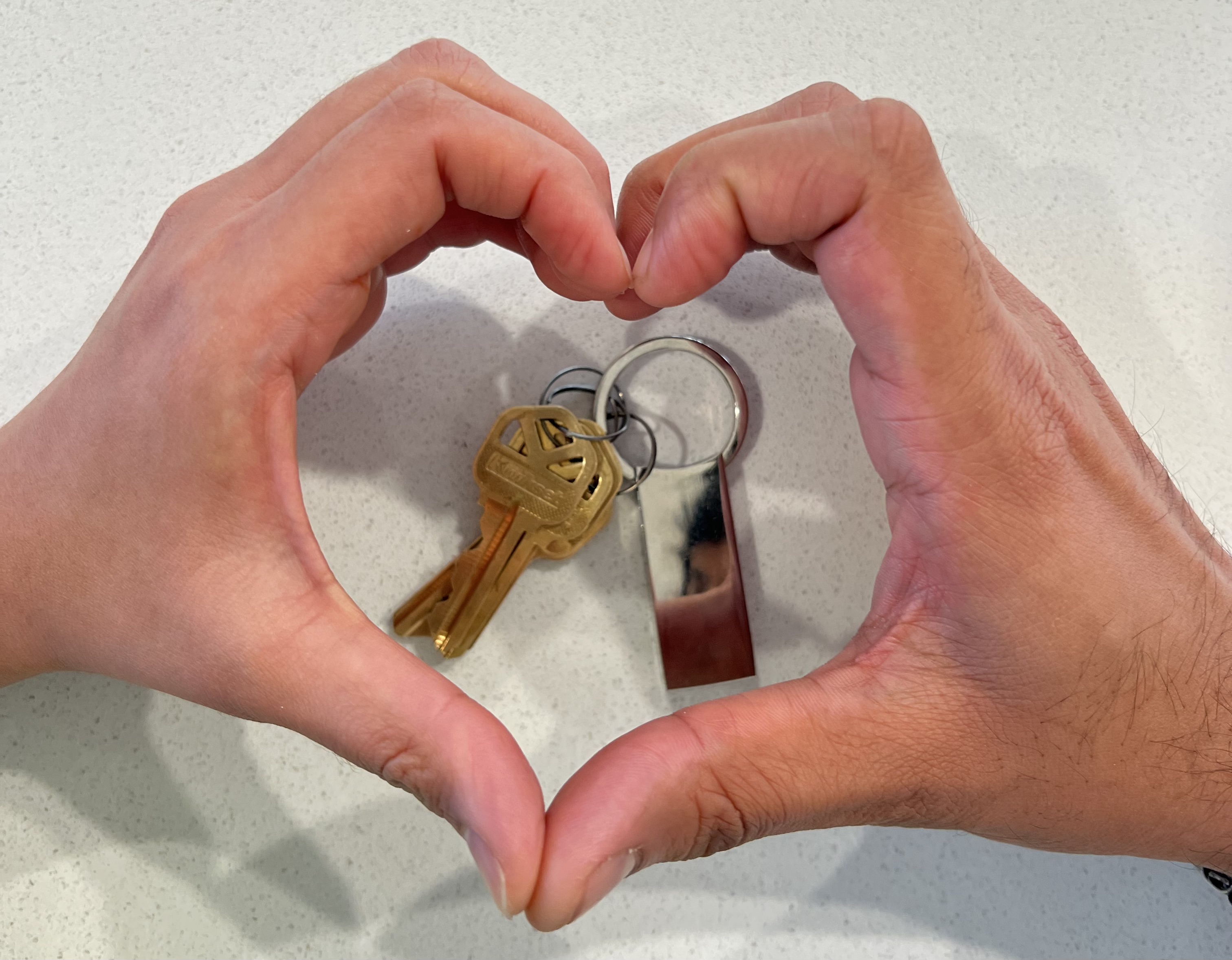 House key in heart hands